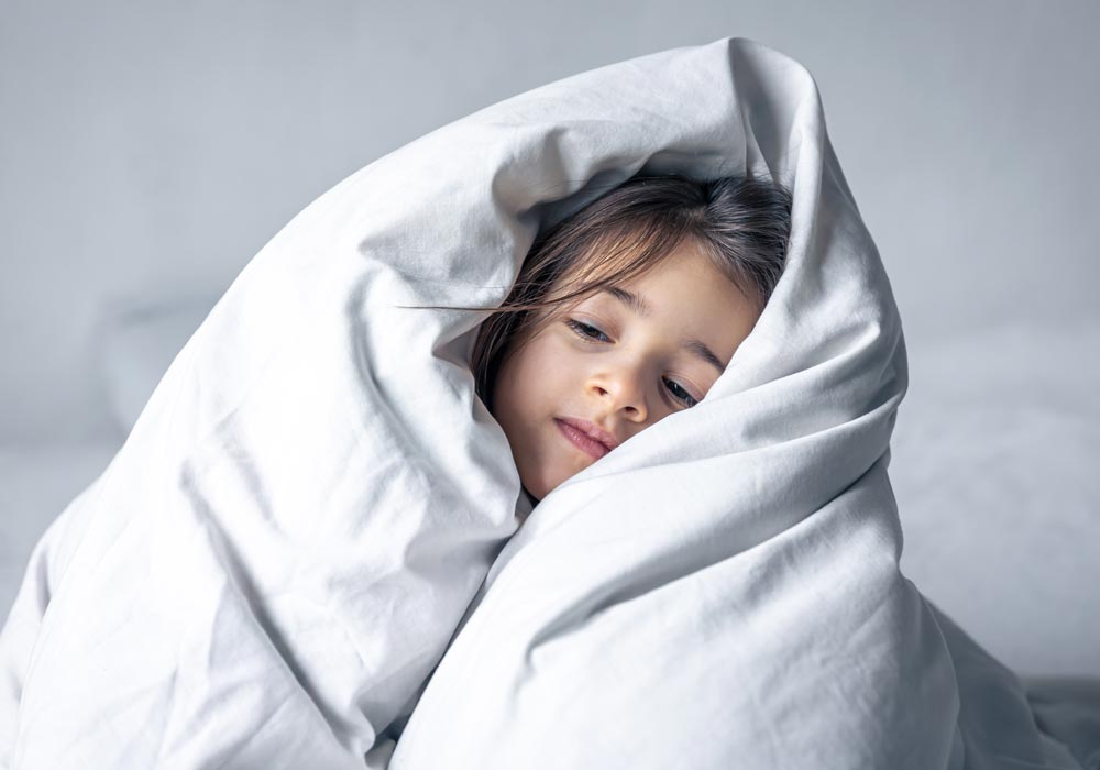 Young girl wrapped in doona