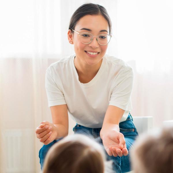 Kinder teacher talking to students